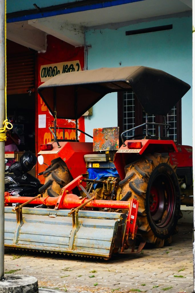 a-red-tractor-with-a-canopy-parked-canopy-vlozv2oquwo