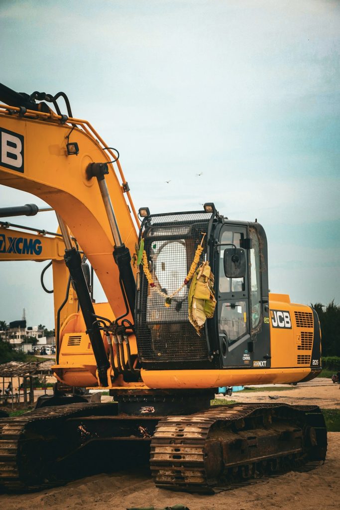 yellow-excavator-parked-on-sandy-ground-outdoors-ltvfagafqa4